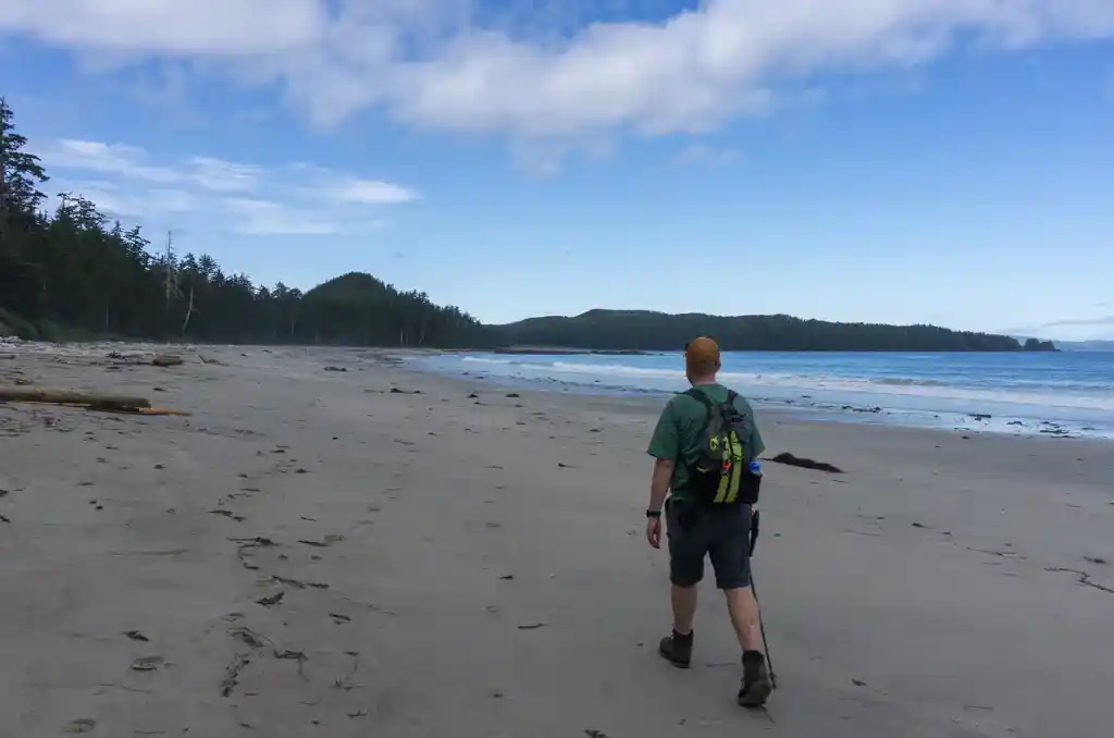A hiker walks on Bowen Beach, Cape Scott Provincial Park