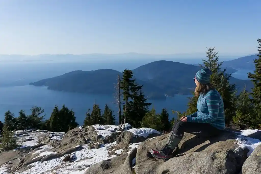A woman wearing gaiters on a winter hike