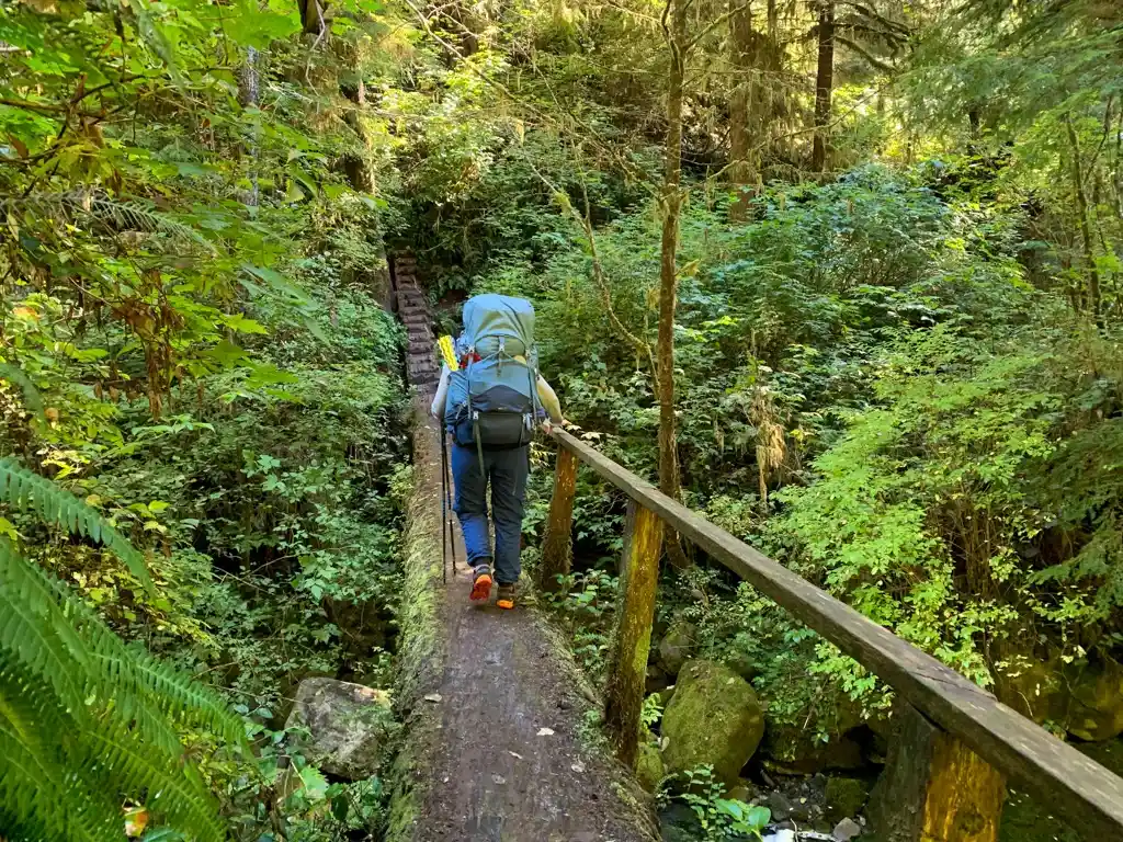 Crossing a log bridge over Yauh Creek on the Juan de Fuca Trail