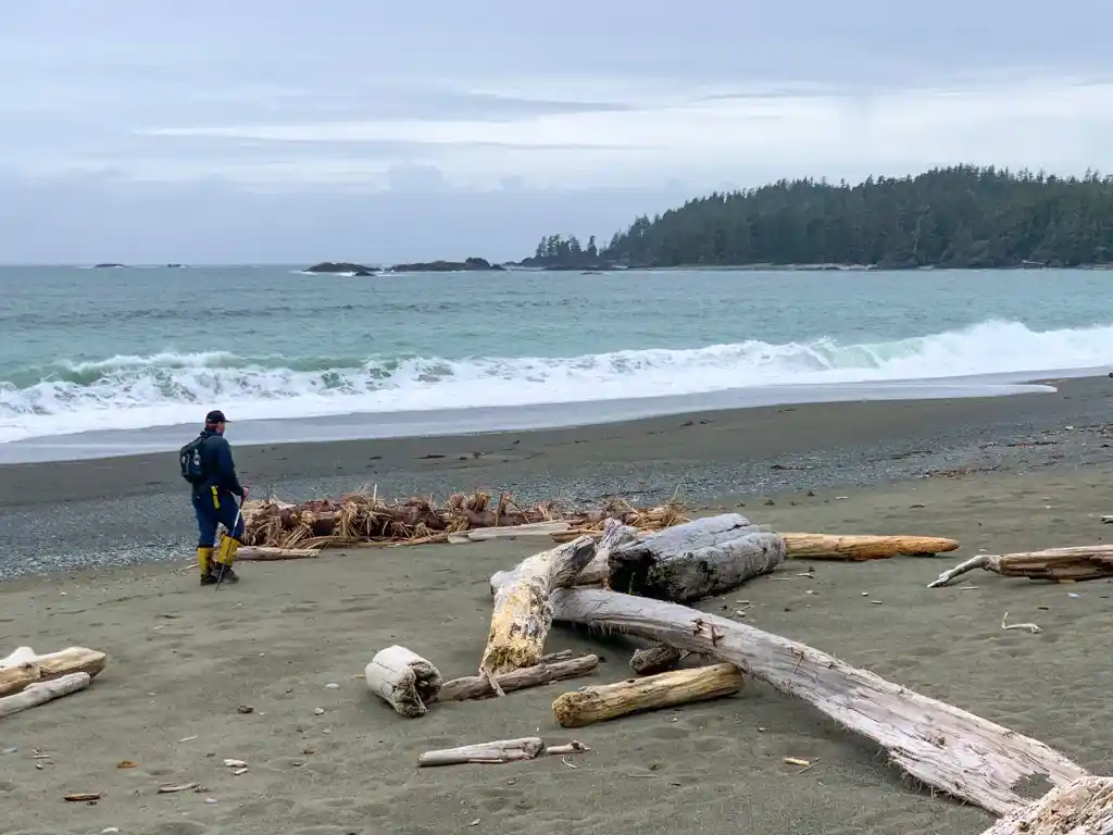 A hiker walks on Keeha Beach near Bamfield, BC in Pacific Rim National Park