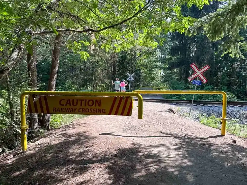 The trail goes through the yellow gate to cross the railway tracks