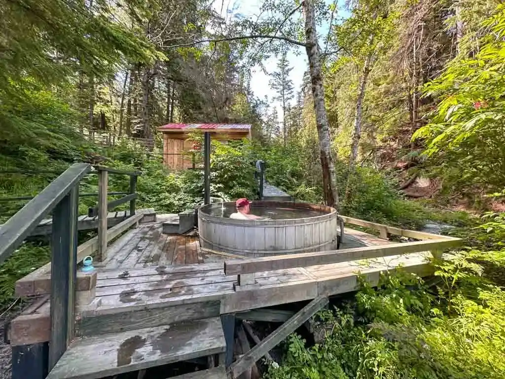 A man sits in the Higu Isgwit Hot Springs in the Nass Valley