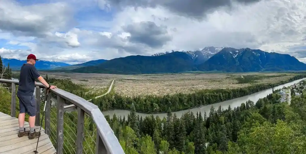 A man stands on the Saasak'Viewing Platform in the Nass Valley