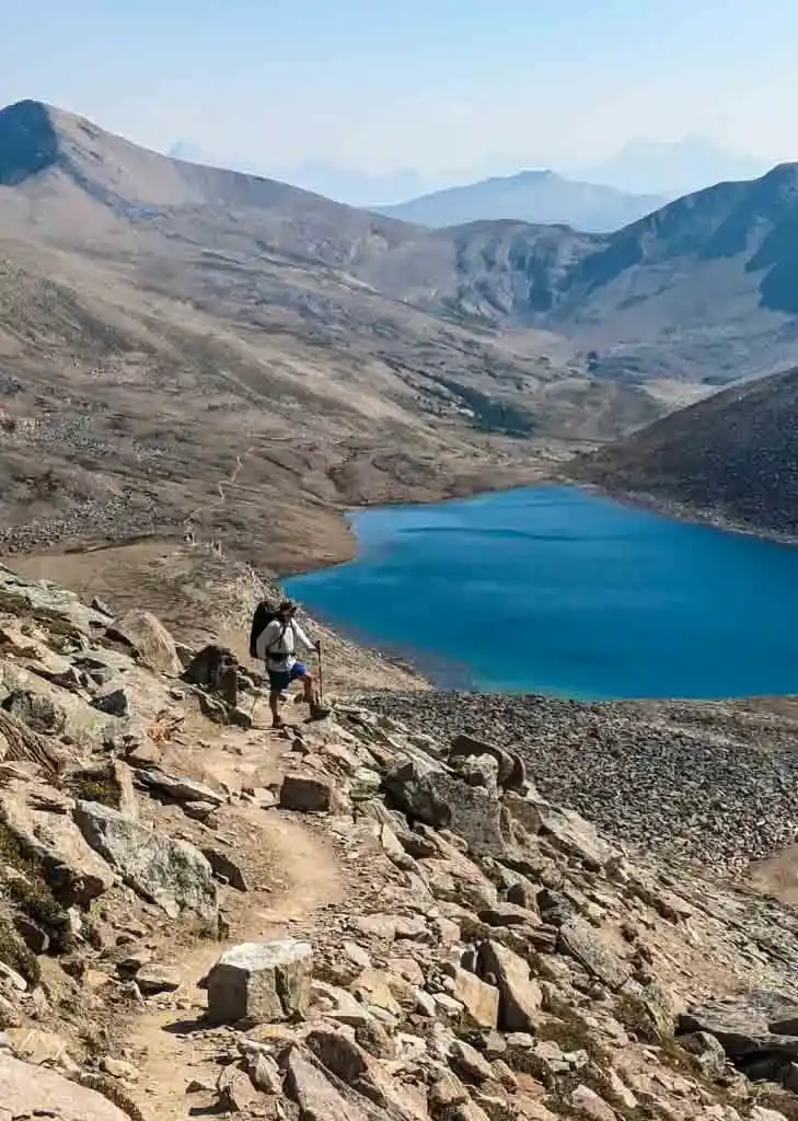 A hiker on the Skyline Trail above Curator Lake on the way to The Notch