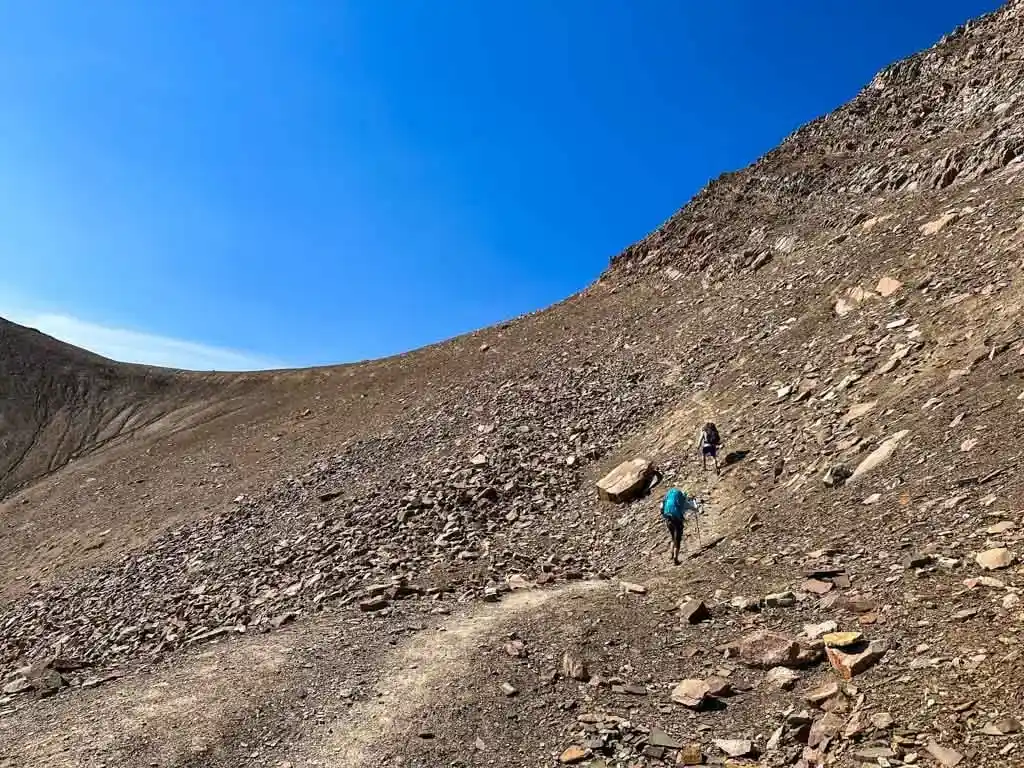 Two hikers climbing The Notch in late August