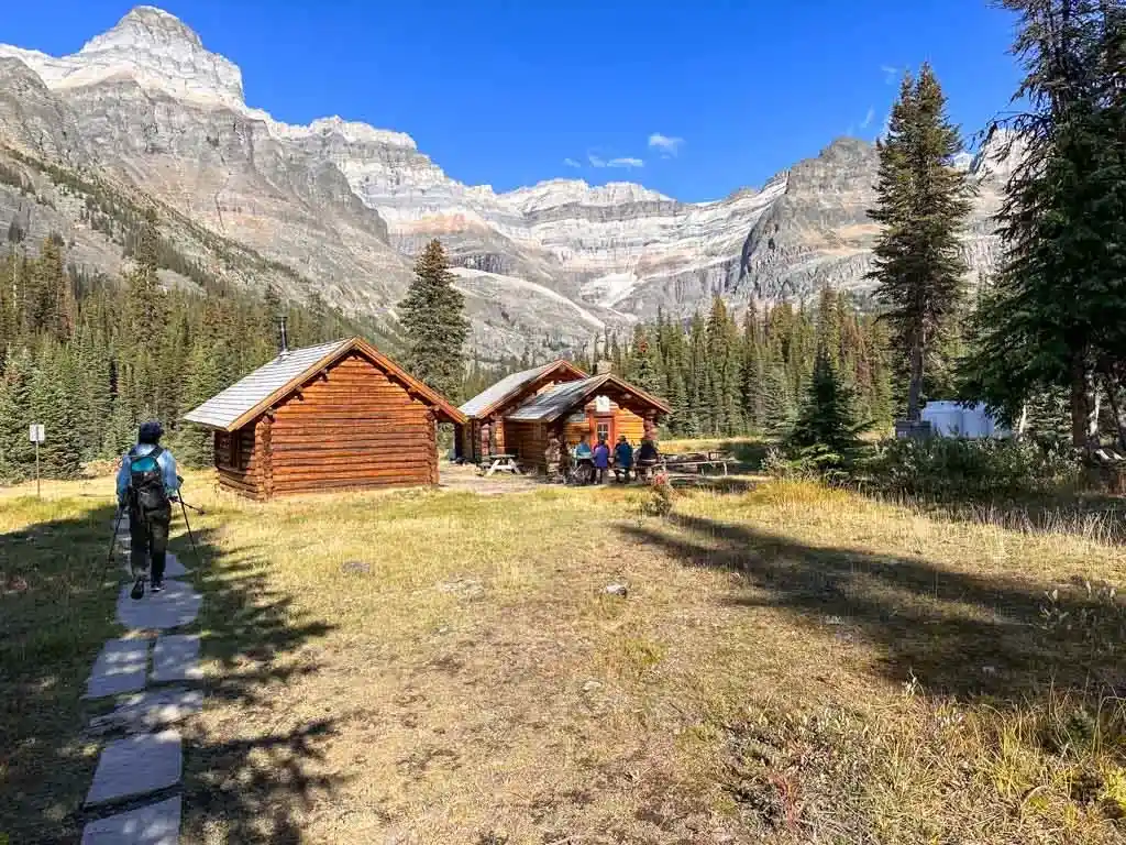 A hiker walks past the Elizabeth Parker Hut at Lake O'Hara