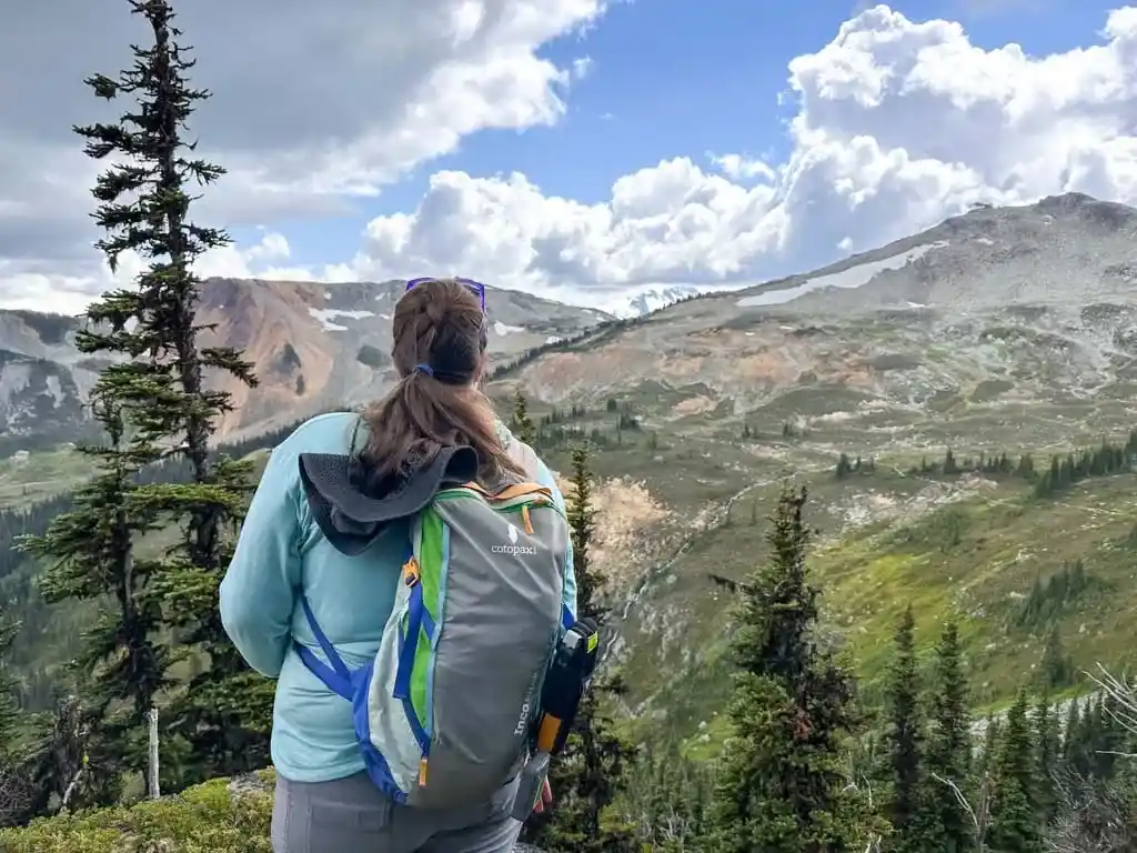 A hiker admires the view of Piccolo Summit and Flute Summit from the High Note Trail