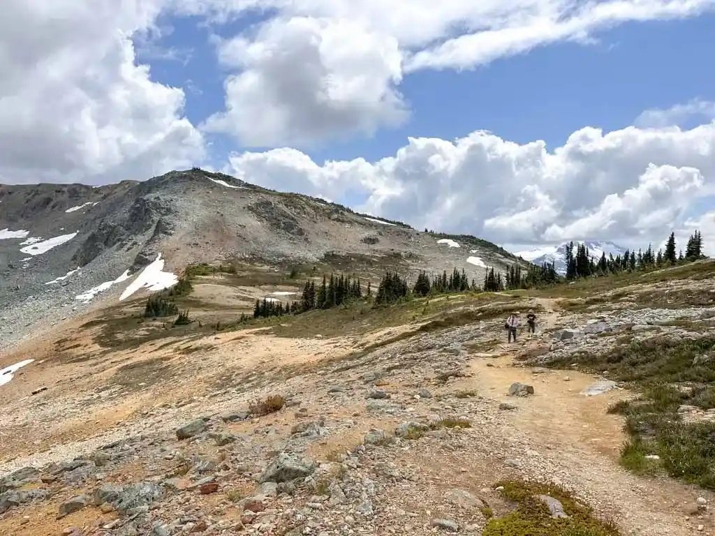 Hiker walk along a rocky trail near Flute Summit