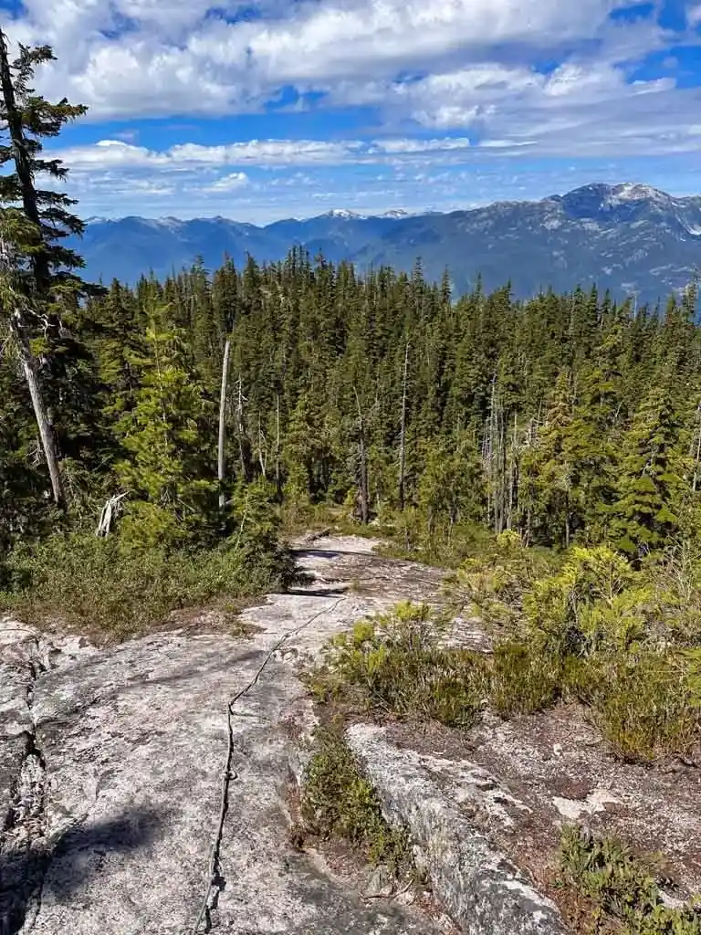 A rope helps you down a rock slab on the Neverland Loop Trail in Squamish