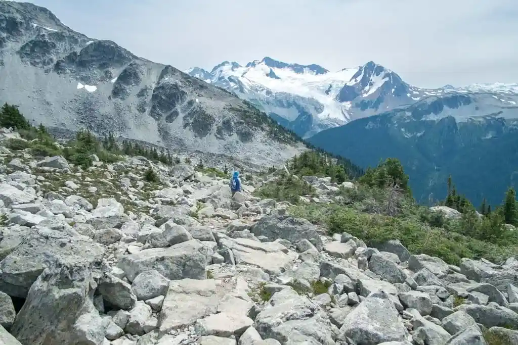 Walking downhill through the rocks towards Decker Tarn on Blackcomb Peak
