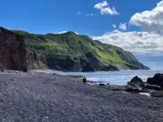 A man hikes on a rocky beach on the Green Gardens Trail in Gros Morne National Park in Newfoundland