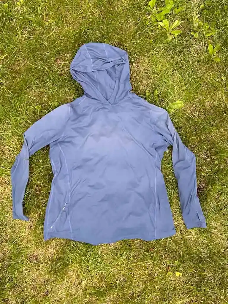 Mountain Hardwear Crater Lake Sun Hoodie laying flat on grass
