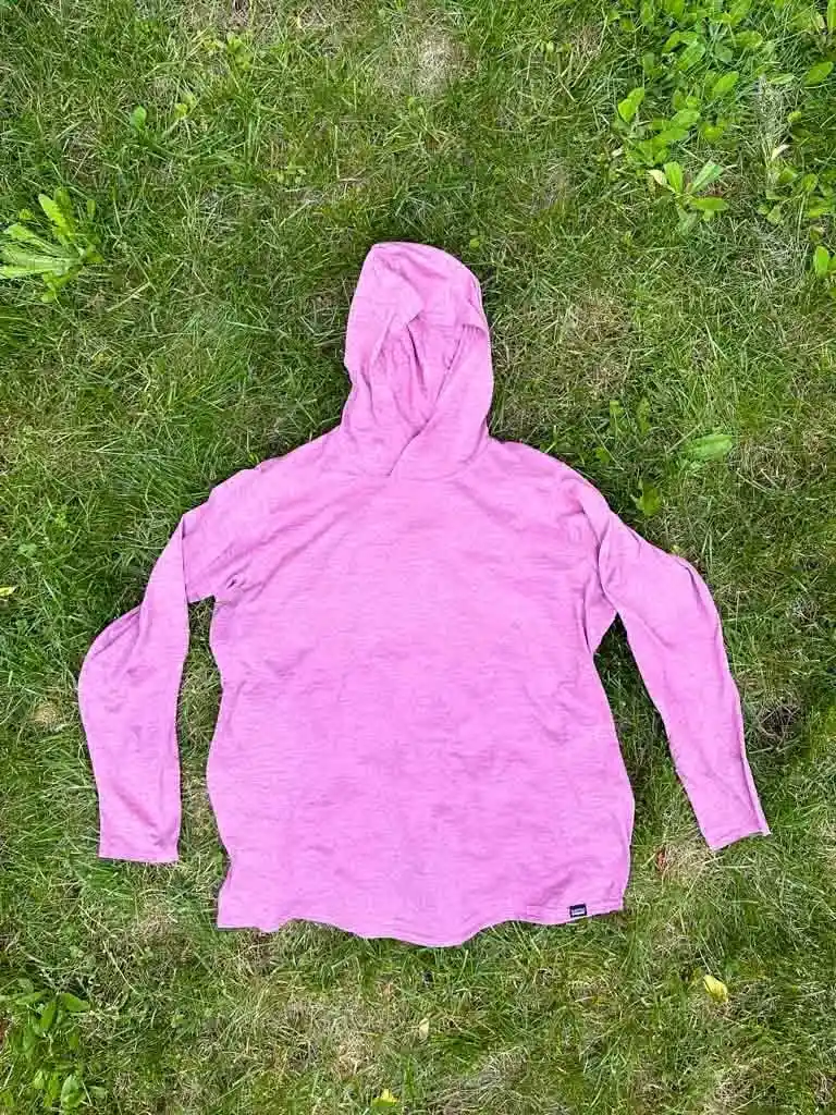 Patagonia Capilene Cool Daily Hoody laying flat on grass