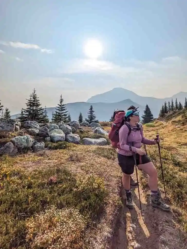 A hiker wears a sun hoodie on a backpacking trip