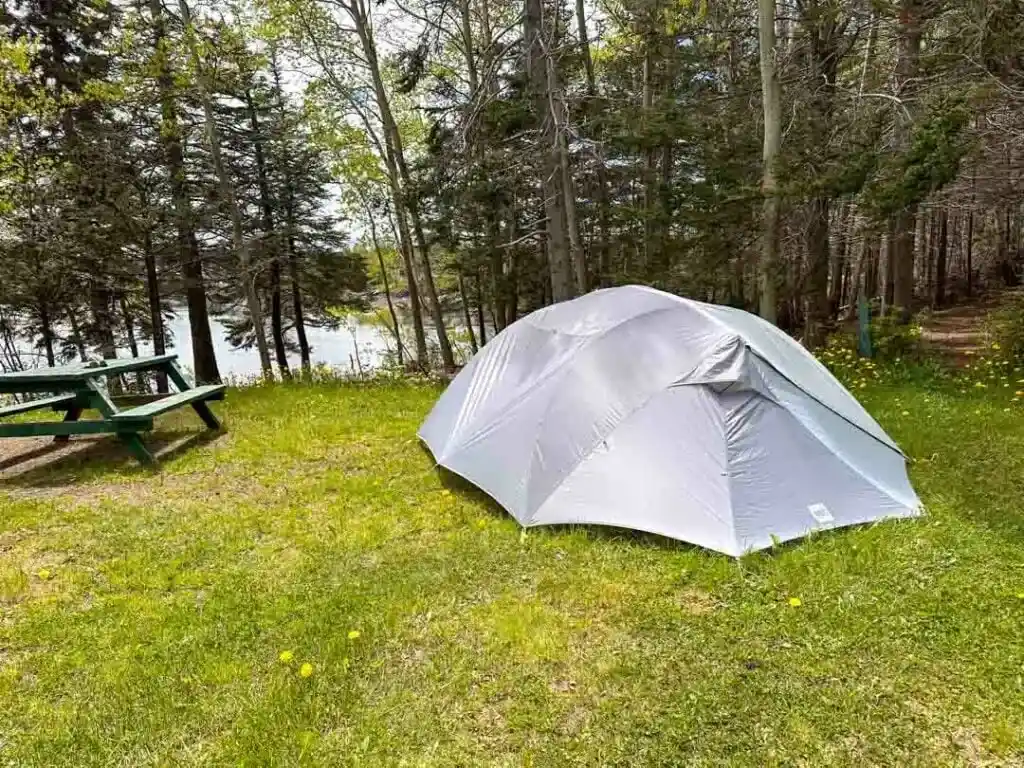 A tent at Dildo Run Provincial Park. You can see the ocean through the trees