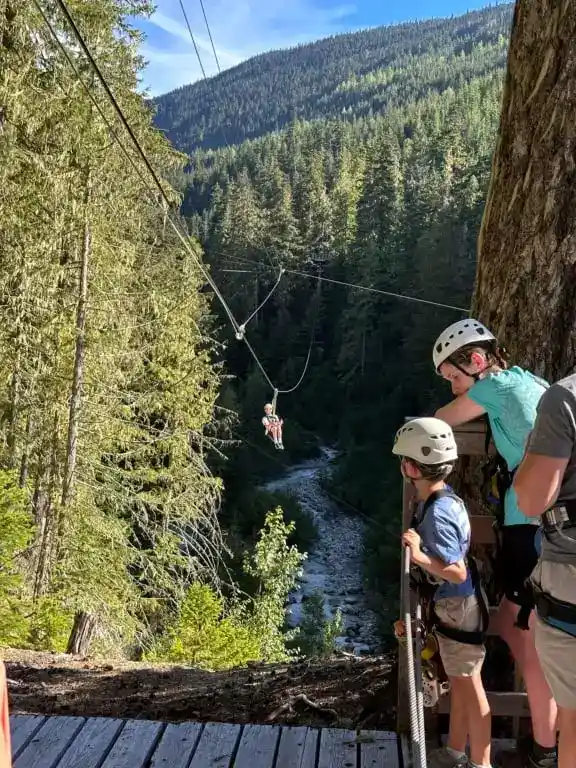 People watching someone zipline at Whistler