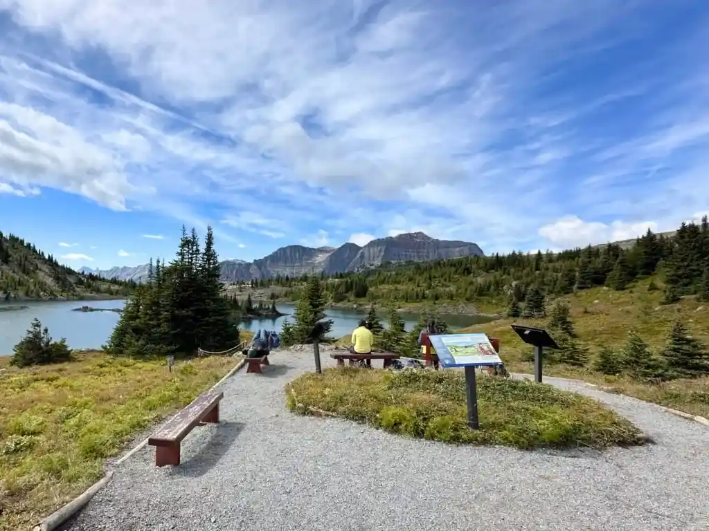 Hikers rest on benches at Rock Isle Viewpoint 